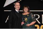 Jeremy Bennett presents Swansway's Sarah Eccles with the Fleet Dealer of the Year trophy at the 2017 Fleet News Awards