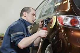 Vehicle repairer at work in a car body shop