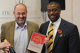 Robin Luscombe, managing director, Luscombe Motors, left, accepts the AM  Best UK Dealerships to Work For  award from LTK Consultants’  managing director, Andrew Landell