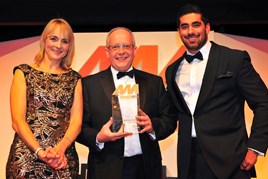Andy Barratt, chairman and managing director of Ford of Britain, centre, accepts the AM Award for Manufacturer of the Year from Kieron Karue, managing director, Touchpoint (right)