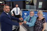 Paul Couchman General Sales Manager (left) hands the keys to their new car over to first customers Trevor and Jean Clarke, watched by General Manager (second left) Matthew Jones