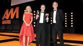 Huw Roberts, group people director, Peter Vardy, collects the award from Steve Le Bas, head of motor retail, and TV presenter Charlotte Hawkins