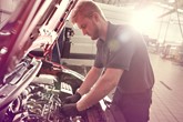 An automotive apprentice at work