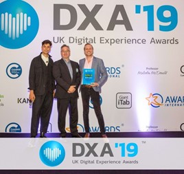 Tom Mapes (far right), Aston Barclay’s group marketing and PR manager, receives the gold award from the Digital Experience team