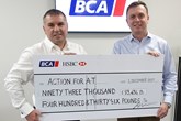 BCA chief commercial officer Craig Purvey (left) presents the cheque to Sean Kelly, Chief Executive, Action for A-T