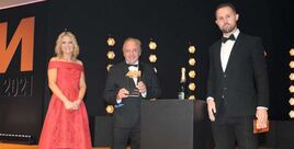 Stuart Foulds, chairman and CEO, TrustFord (centre), picks up the trophy from Dan Delderfield, national field account manager, CarGurus PistonHeads