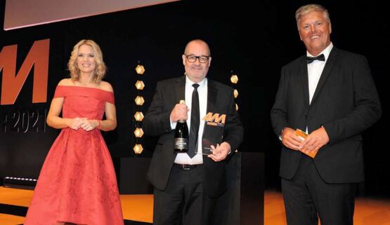 Simon Palmer, used car sales director  at Hendy Group (centre) receives the award from Malcolm Thixton, partner at awards auditors BDO