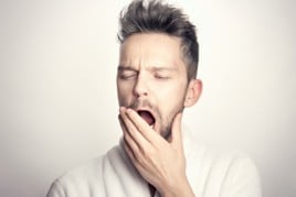 Unsplash stock pic of a man ywaning with boredom