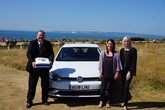 Martin Pye and Jennie Mitchell recreate a 2004 photograph with Café Riva owner, Becky Green as they sold their 20,000 vehicle.