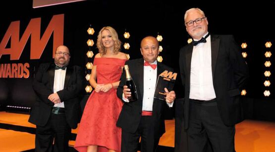 Daksh Gupta, Marshall Motor Group chief executive (second from right), receives his award from Ian Simpson, director, Premia Solutions (right) and AM editor Tim Rose