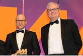 Darren Edwards, chief executive,  Sytner, left, collects  the award from Ian Simpson, sales  and marketing director, Premia  Solutions