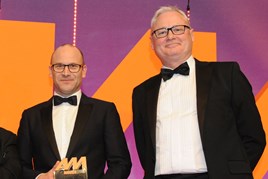 Darren Edwards, chief executive,  Sytner, left, collects  the award from Ian Simpson, sales  and marketing director, Premia  Solutions