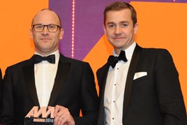 Darren Edwards, chief executive,  Sytner, collects the award from Richard Jones, managing director, Black Horse, right