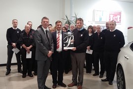 Kia Motors UK CEO Paul Philpott (centre, left) presents Flear and Thomson directors Scott Buchanan and Paul Buchanan with the dealership's Platinum Prestige Award