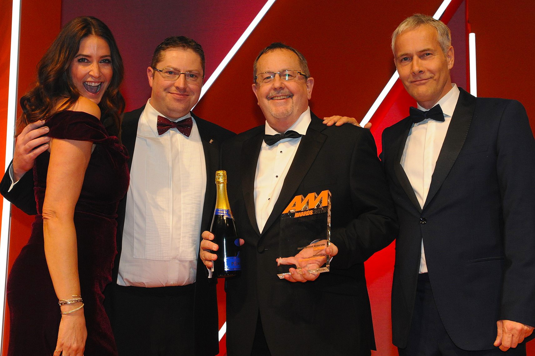 Gordon Veale, general manager, Carbase, (second from right) and Alex Jones, marketing manager (second from left) collects the award from Robert Hutchinson, sales director Motor Finance, BNP Paribas Personal Finance, right and host Lisa Snowdon left