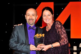 Kevin Davidson, retailer development director, BMW Group UK, accepts the award for  Digital Initiative of the Year from Sharon Randall, UK sales director, Auto Trader