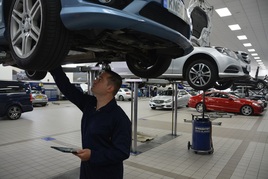 A car technician carries out checks on a vehicle