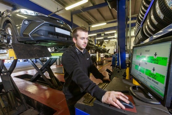 Wheel alignment being carried out by a Kwik Fit technician