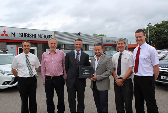 Celebrating its 2016 Mitsubishi milestone (left and right): Livery Dole sales consultant Peter Ackford, chairman Nigel Clegg, sales and marketing director at Mitsubishi Motors in the UK Toby Marshall, managing director Hayden Williams, service manager Chris Ellison and workshop manager Andrew Godbeer