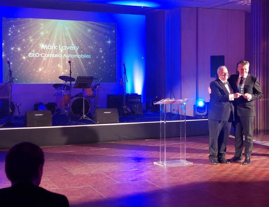 Cambria Automotive boss Mark Lavery receives his award at the NFDA Spring Ball