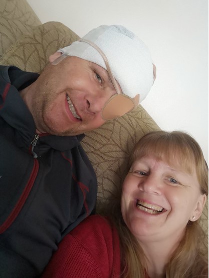 Car dealer Mark Calaz recovering from surgery last year with the help of his wife, Mandy