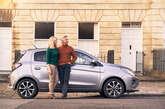 Couple standing near vehicle