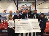 Staff from Motorpoint Sheffield present Michelle Osborne, charity fundraising executive at Cash for Kids, with a cheque following their drive-in cinema event