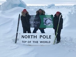Aston Barclay on top of the world: Break-Point director Jason 'Foxy' Fox (centre) with two of his fellow adventurers hoisting the Aston Barclay banner
