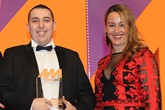Oussama Kadid, sales manager,  Motor Village Marylebone,  collects the award from Wendy Harris, vice-president of EU sales, CarGurus, right