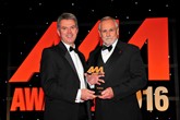 Paul Philpott, president and CEO Kia Motors UK and Ireland (left), collects the award for Used Car of the Year from Mike Cowling, head of product, Car Care Plan