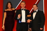 Paul Philpott, president and chief executive, Kia  Motors (UK), accepts the award from Martin Dew,  digital solutions director, Autoweb Design, right and host Lisa Snowdon, left