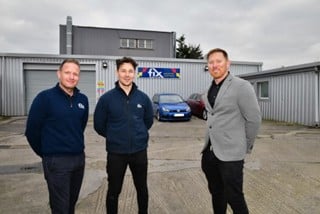 Ashley (right) and Dan Mustoe stand alongside Fix Auto UK’s head of business development Martin Willis