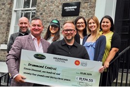 Paul Keighley, PK Motors' managing director, hands over a cheque for over £11,000 to Dan Appleby and members of the fundraising team at Drummond Central 