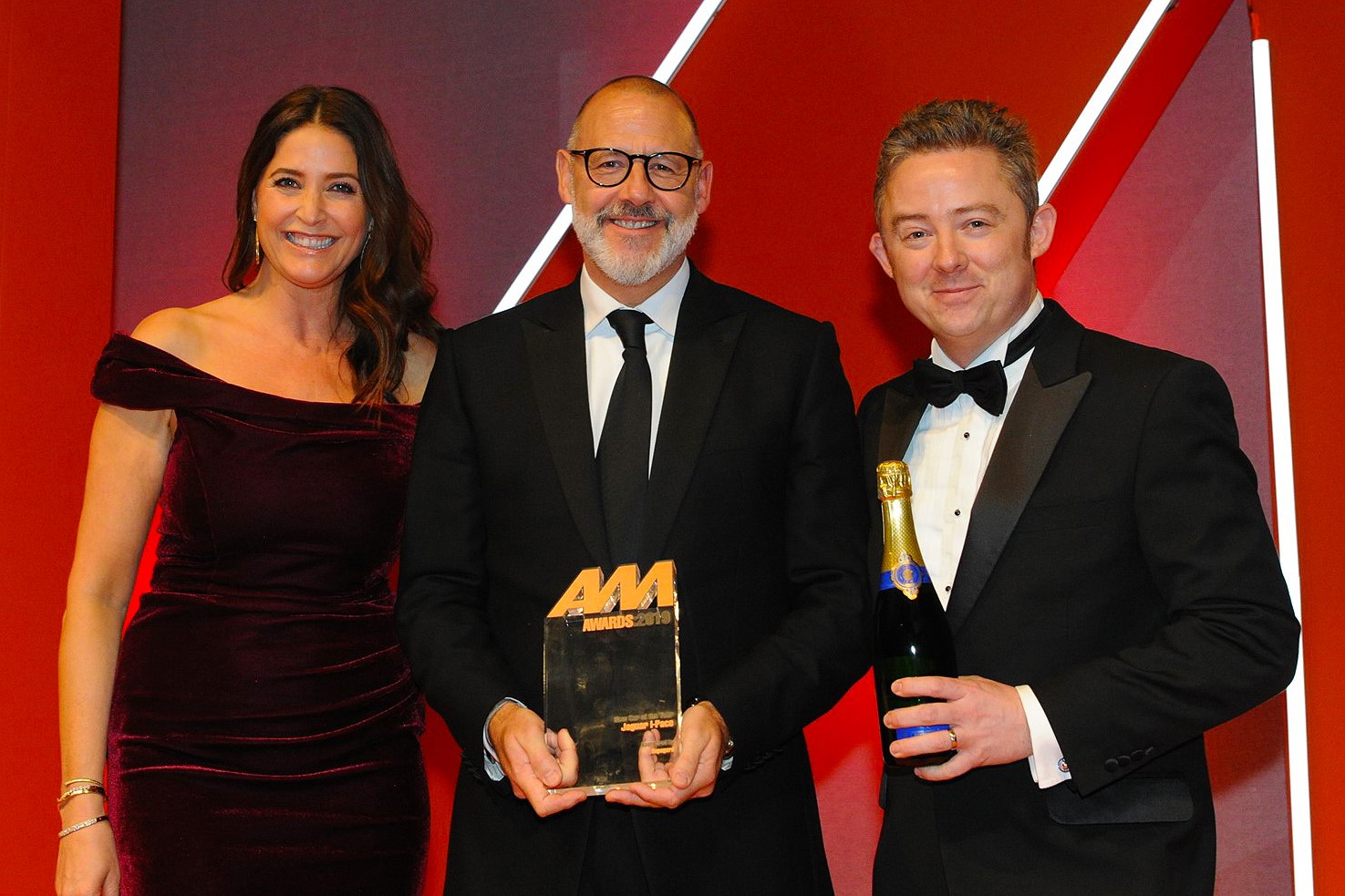 Rawdon Glover, UK managing  director, Jaguar Land Rover,  collects the award from  David Paterson, marketing  director, Supagard, right, and Lisa Snowdon, left