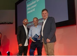 Robin Luscombe, managing director of Luscombe Motors (centre) collects his Retailer of the Year award at the Auto Trader Retail Awards 2018