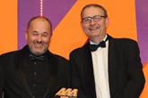 Robin Luscombe, managing director, Luscombe Motors, collects the award from Adrian  Willard, sales director, EMaC, right