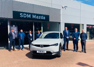 SDM Mazda's (from left) Steven Learmonth, Lewis Wood, Helen Aitken, Niall Syme and John Mallis with Mazda UK Head of Network Strategy Brett Hague and sales director Peter Allibon