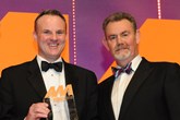 Simon Hetherington, commercial director, Kia Motors UK, collects the  award from Philip Morrison, head of corporate sales, Car Care Plan, right 