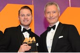 Simon Priest, centre principal,  Porsche Centre Wolverhampton, collects the award from Mark Gow, sales director, DSG Finance, right 