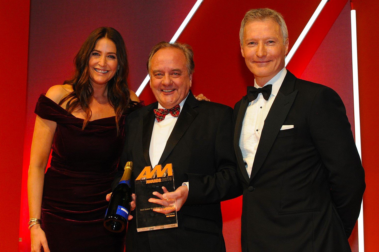 Stuart Foulds, chairman and chief executive, TrustFord, accepts the award from Mark Gow, sales director, DSG Finance, right, and host Lisa Snowdon, left