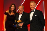 Stuart Foulds, chairman and chief executive, TrustFord, accepts the award from Mark Gow, sales director, DSG Finance, right, and host Lisa Snowdon, left