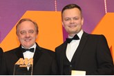 Stuart Foulds, chairman and  chief executive, TrustFord, collects the award from  Marc Robinson, sales director,  Motors.co.uk, right