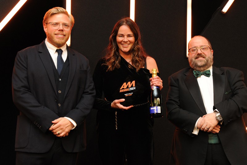 Auto Trader's sales director Rebecca Clark receives the Supplier of the Year Award from AM editor Tim Rose (right)