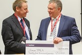 David Smyth (right) presents Crewe YMCA's Richard Holmes with £25,000 donation