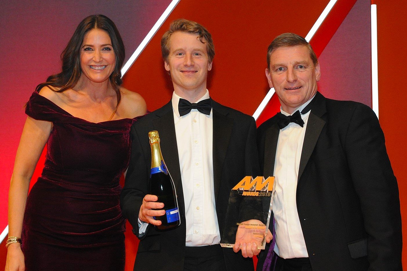 Tim Holden, chief executive,  Holden & Holden, accepts the  award from Michael McVeigh, chief operating officer, AutoProtect, right, and host Lisa Snowdon, left