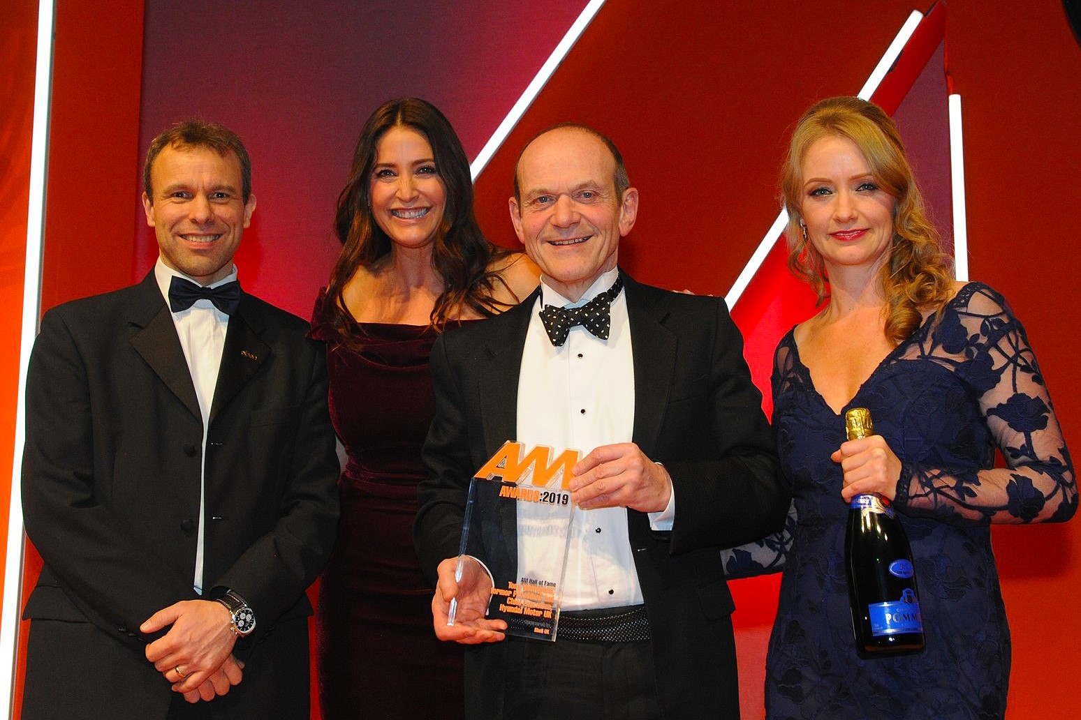 Tony Whitehorn, former chief executive, Hyundai Motor UK, accepts the award from Katie Rugen, UK automotive sales team lead, Shell UK, right, AM editor-in-chief Stephen Briers, left, and host Lisa Snowdon, second from left