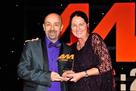 Kevin Davidson, retailer development director, BMW Group UK, accepts the award for  Digital Initiative of the Year from Sharon Randall, UK sales director, Auto Trader