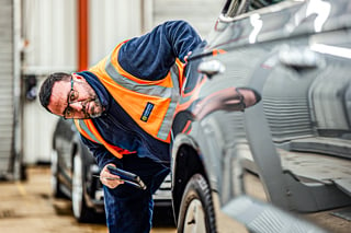 Manheim employee carrying out vehicle inspection