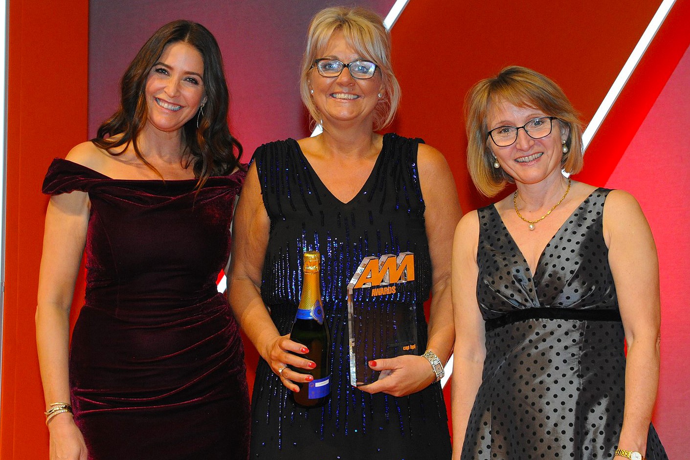 Wendy Swaine, head of sales (retail), Cap HPI,  accepts the award from Julia Pennington, managing  director, Copeland Automotive Recruitment, right, and host Lisa Snowdon, left