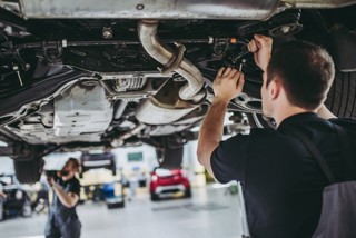 A technician at a work on a car